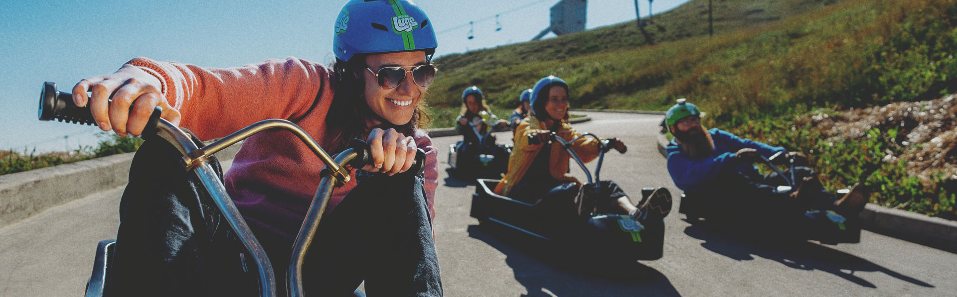 Young riders speeding down the track during a downhill karting session at WinSport