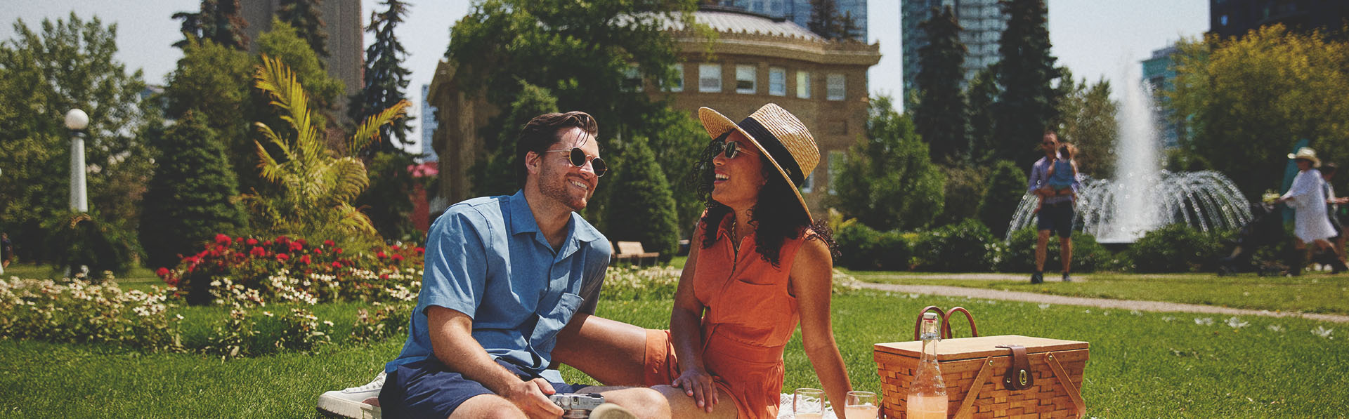 couple laughing and enjoying picnic at Central Memorial Park in Calgary