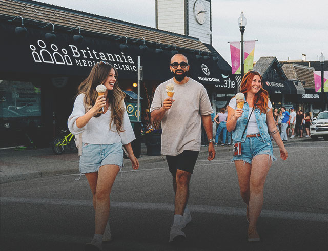 group of friends walking and enjoying ice cream from Village Ice Cream
