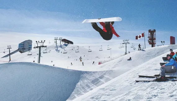 snowboarder jumping at WinSport ski hill in Calgary