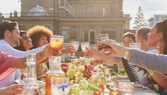 group dining at a long table during a private event held at Lougheed House during spring