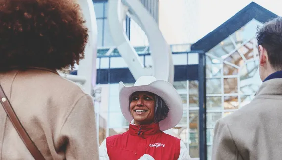 a lady smiling and talking to a group of delegates