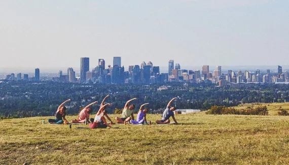 a group of people practicing yoga at Nose Hill park