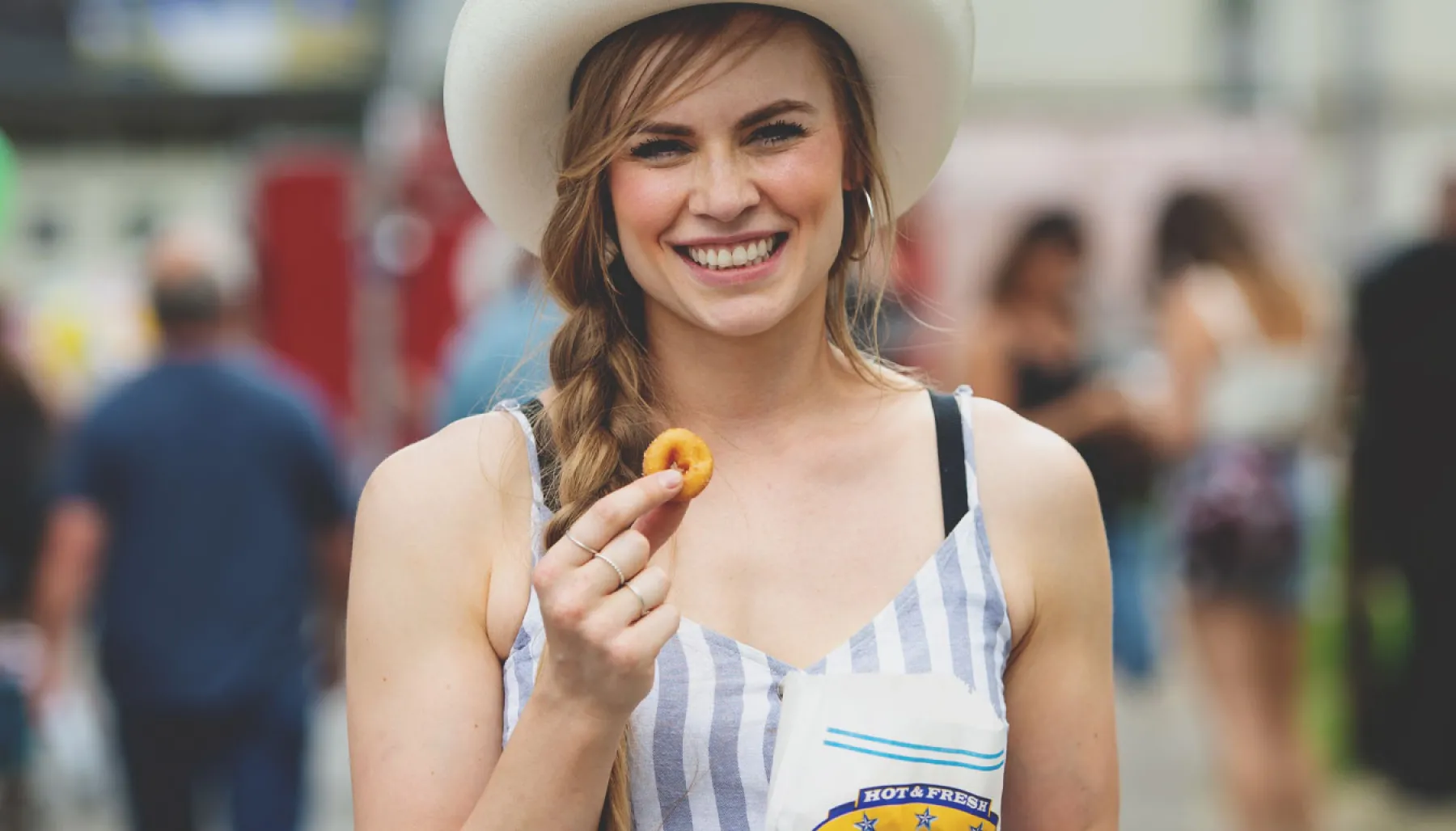 Stampede go-er snacking on mini-doughnuts