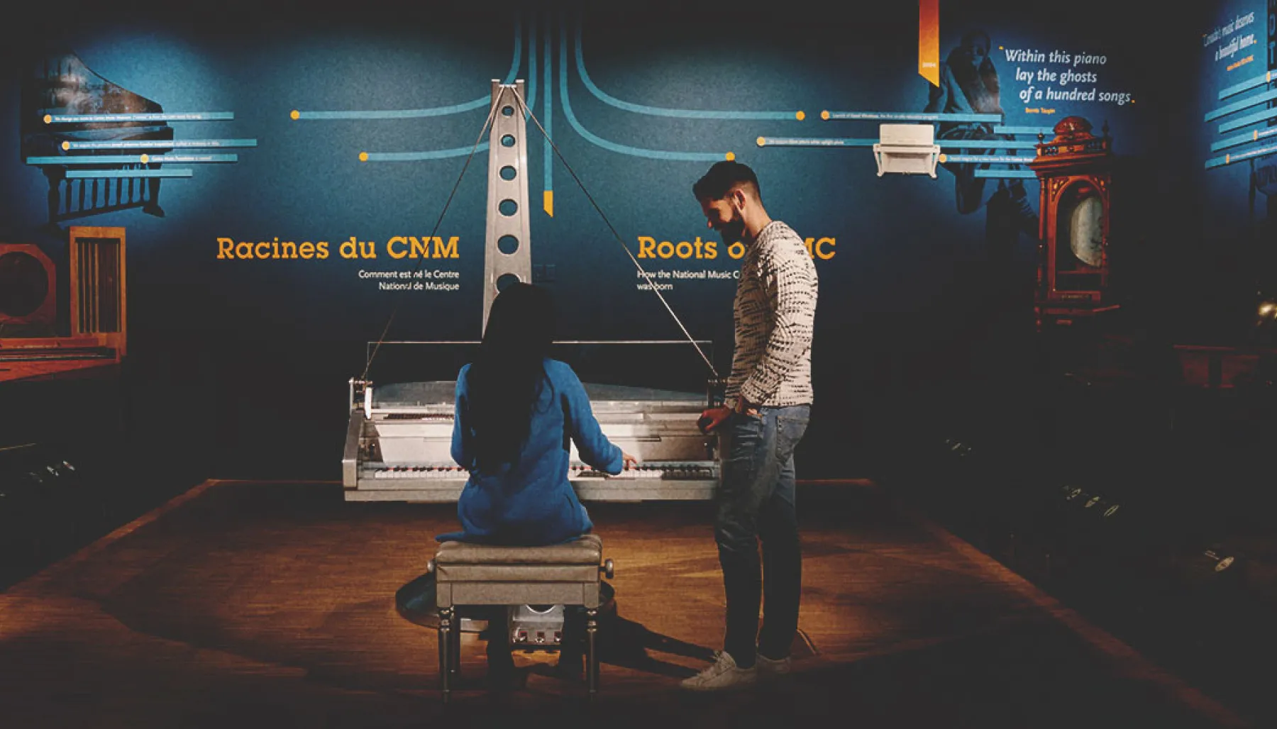 Two people playing piano at Studio Bell