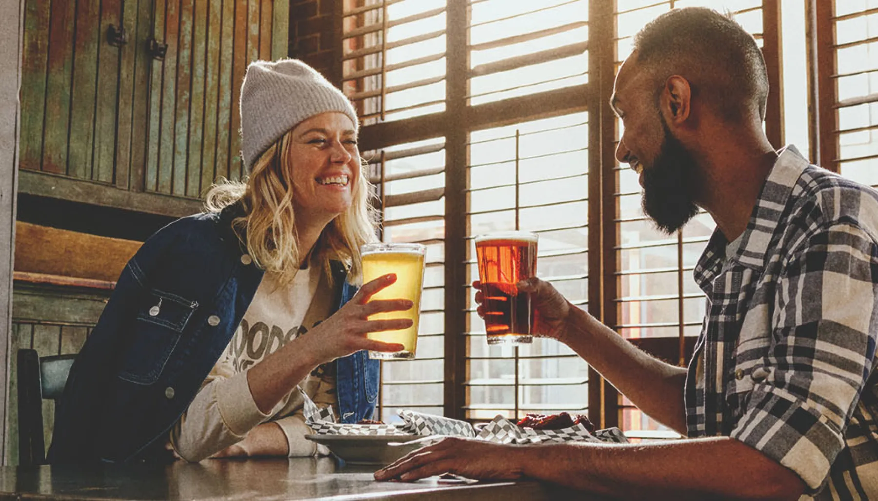 Couple drinking beer inside the Palomino in early spring