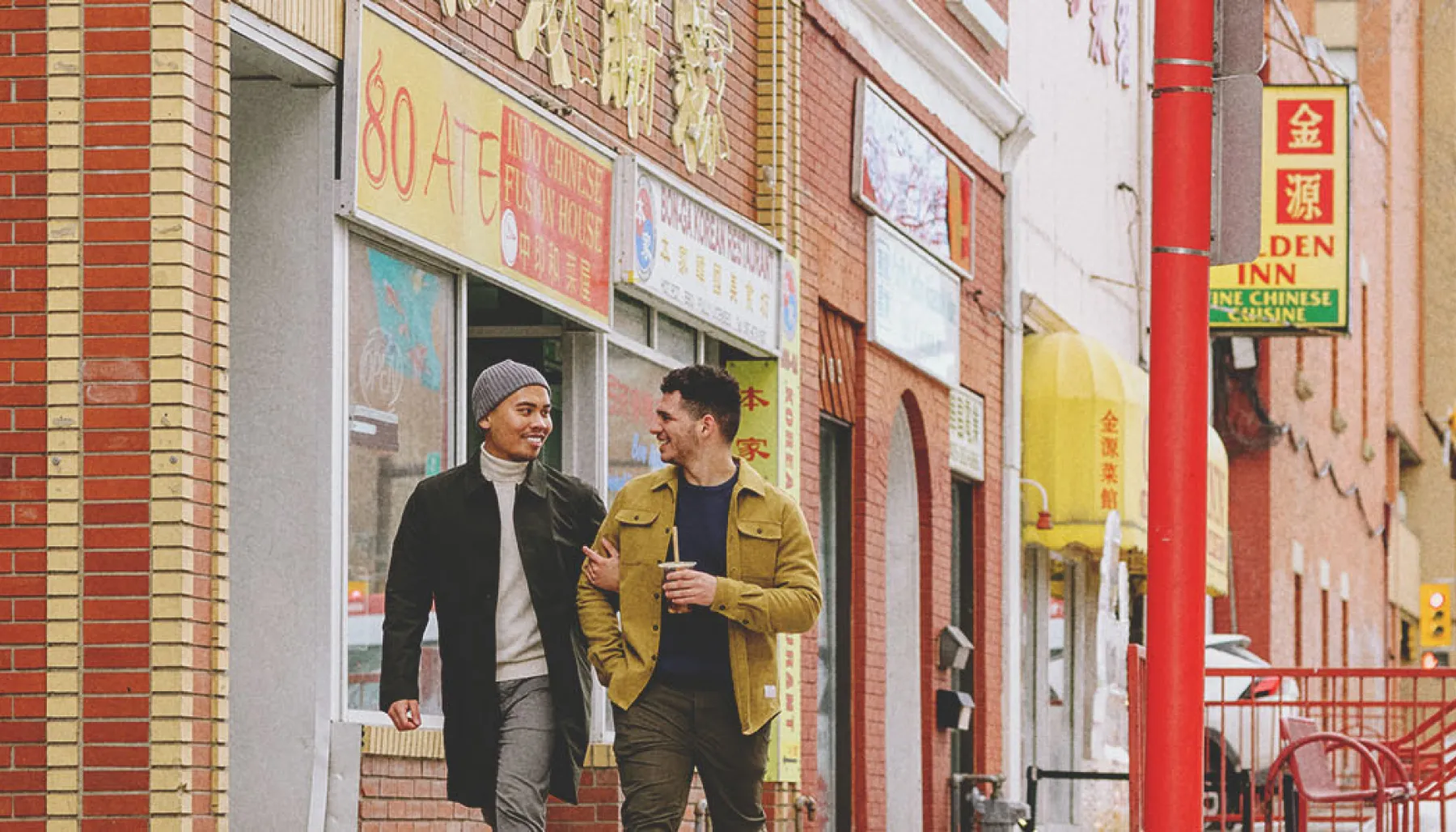 Couple walking through Calgary's Chinatown in winter