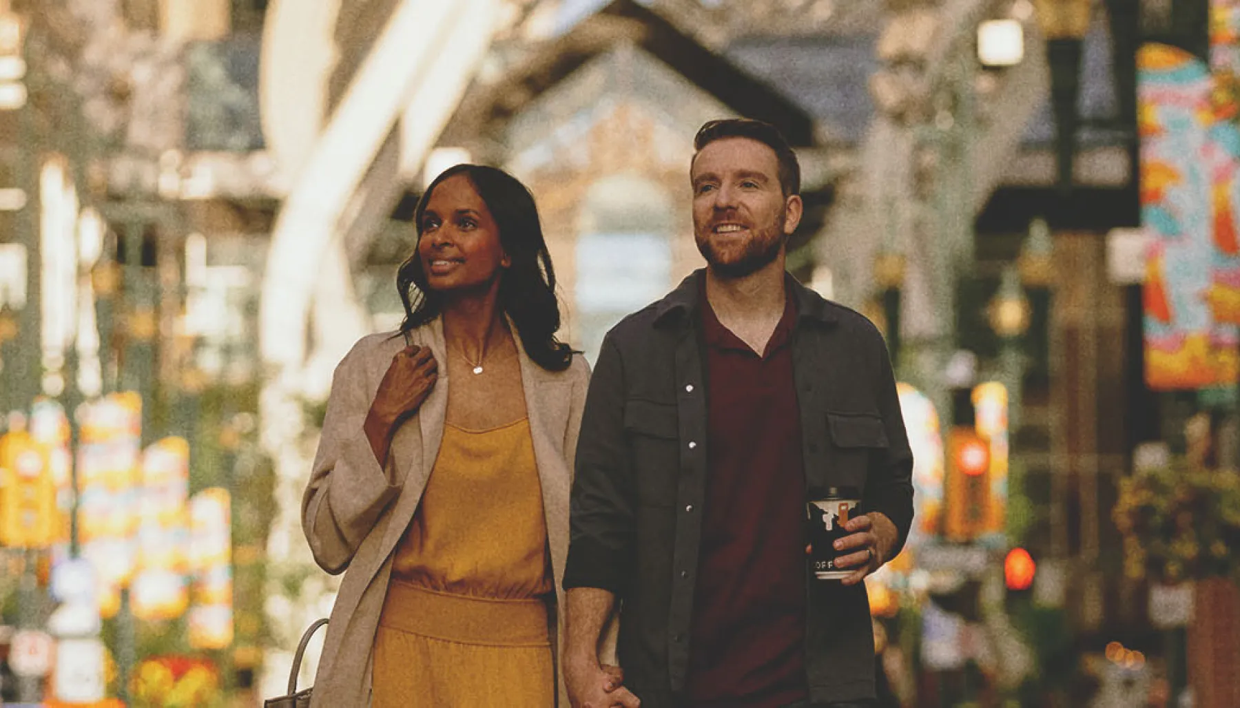 Couple walking along Stephen Avenue in summer
