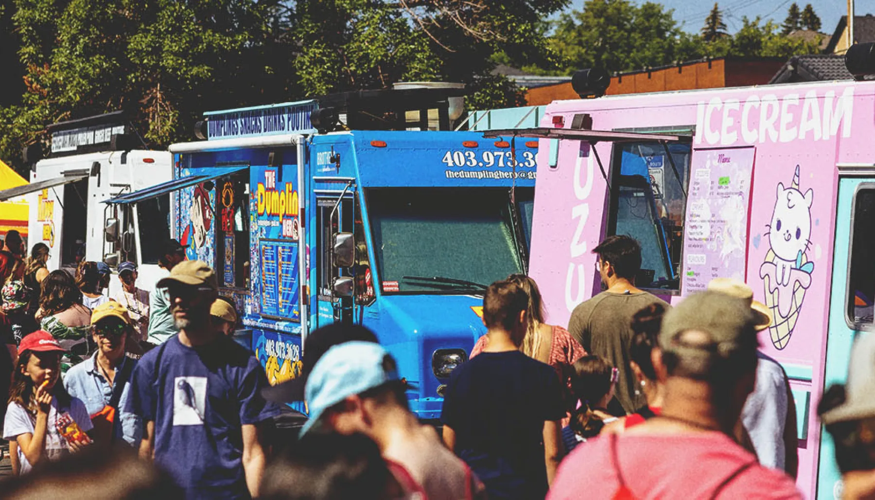 crowds of people ordering from food trucks at Marda Gras Street Festival