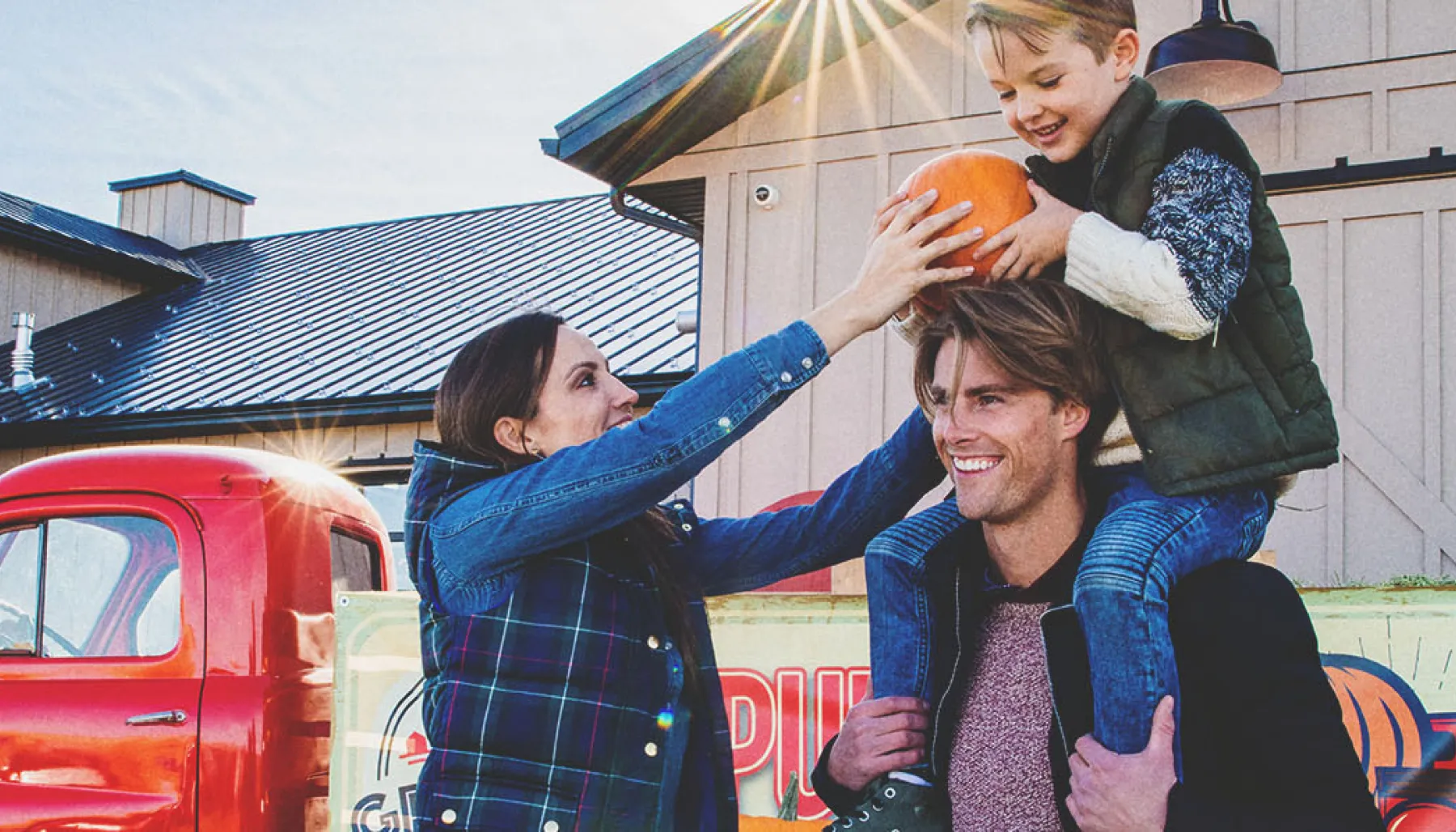 family in the pumpkin patch at Granary Road during autumn
