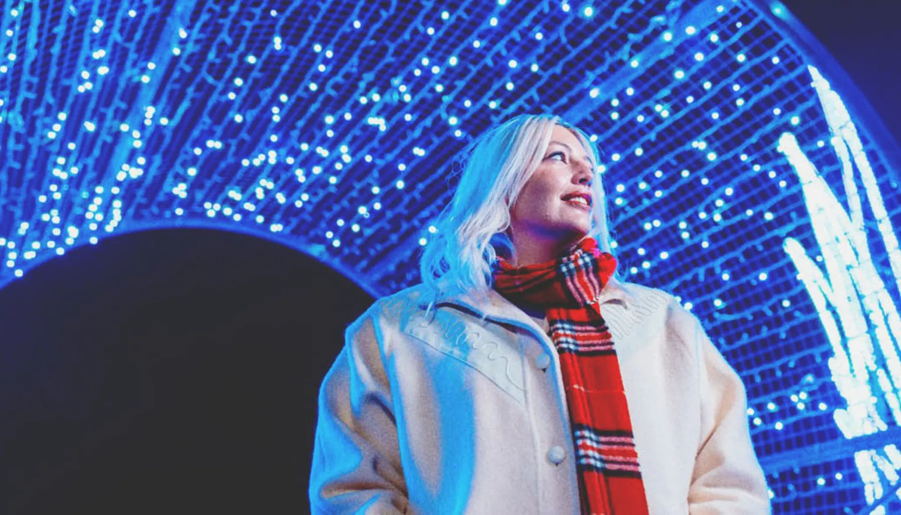woman exploring the holiday light displays at ZOOLIGHTS