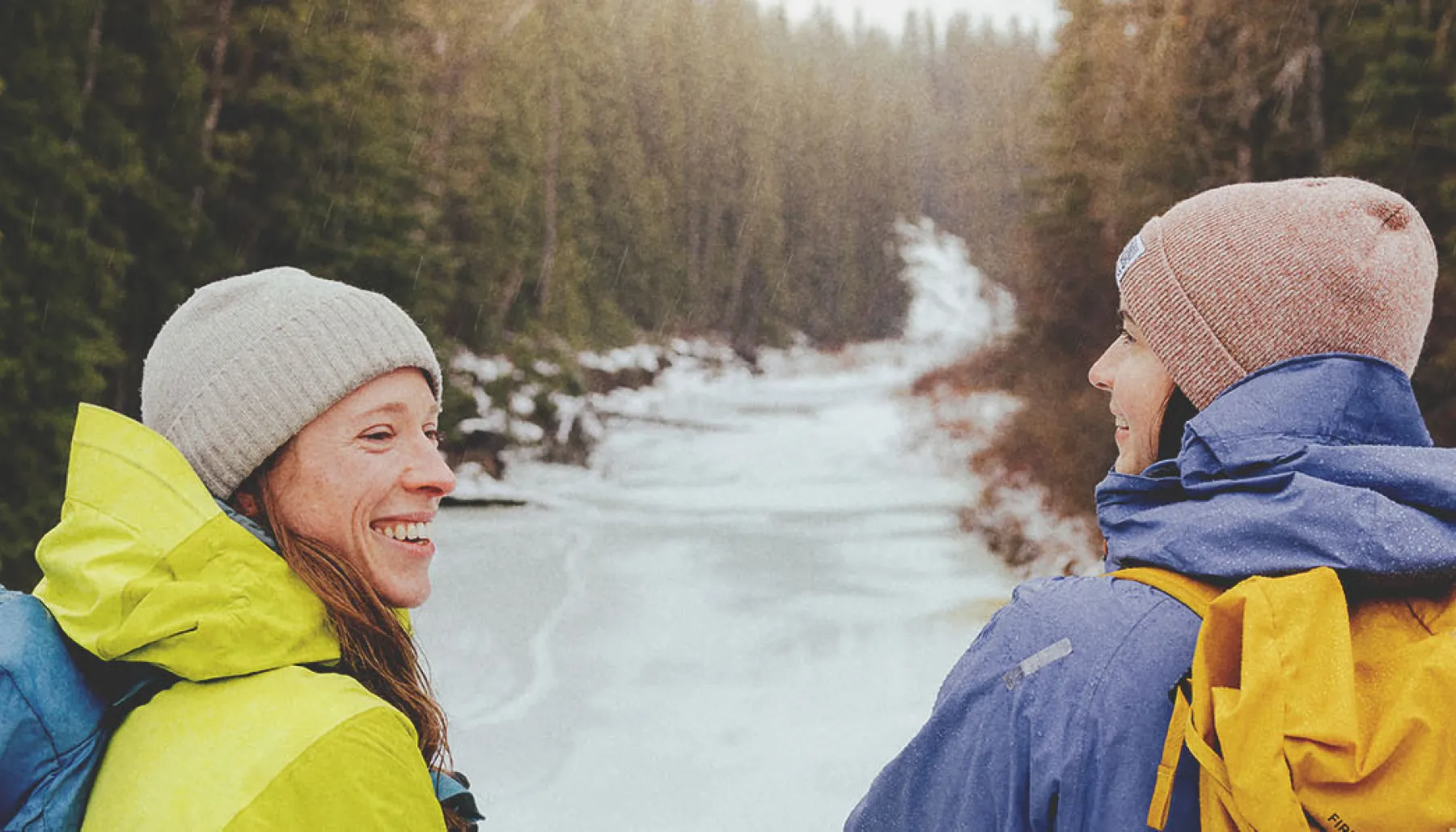 Two ladies hiking through Fish Creek Park during winter