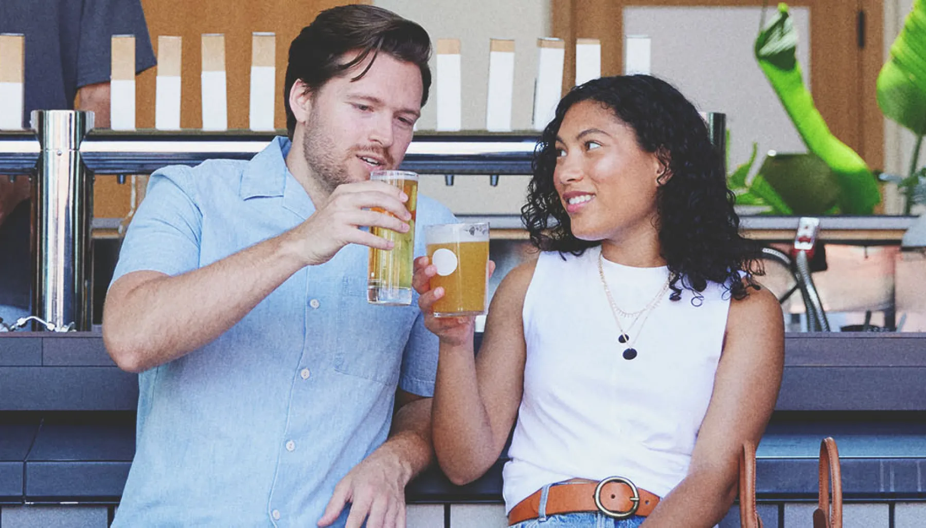 Couple enjoying pints of beer outside at 33 Acres Brewing Co in Calgary's beltline