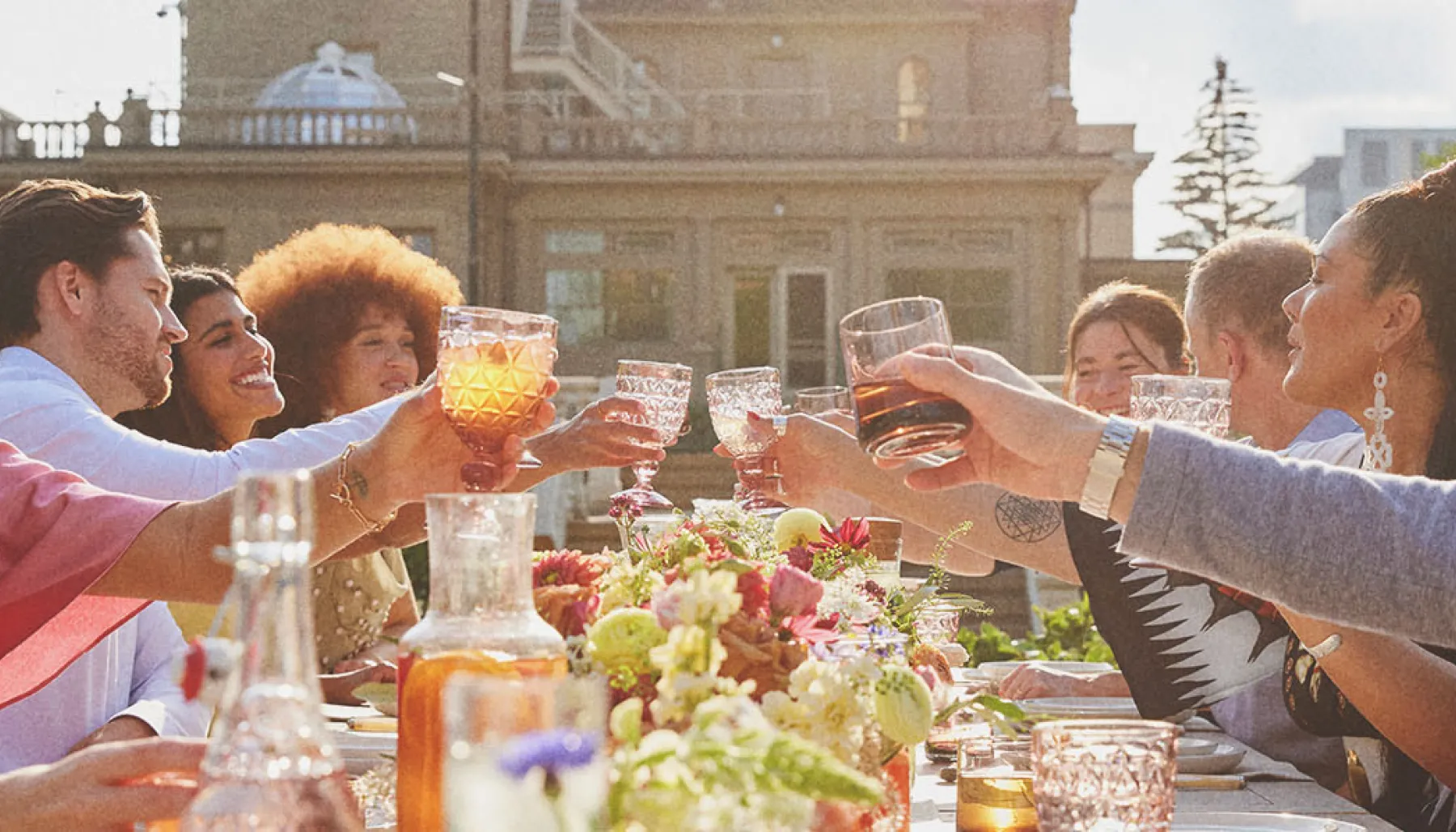 group dining at a long table during a private event held at Lougheed House during spring
