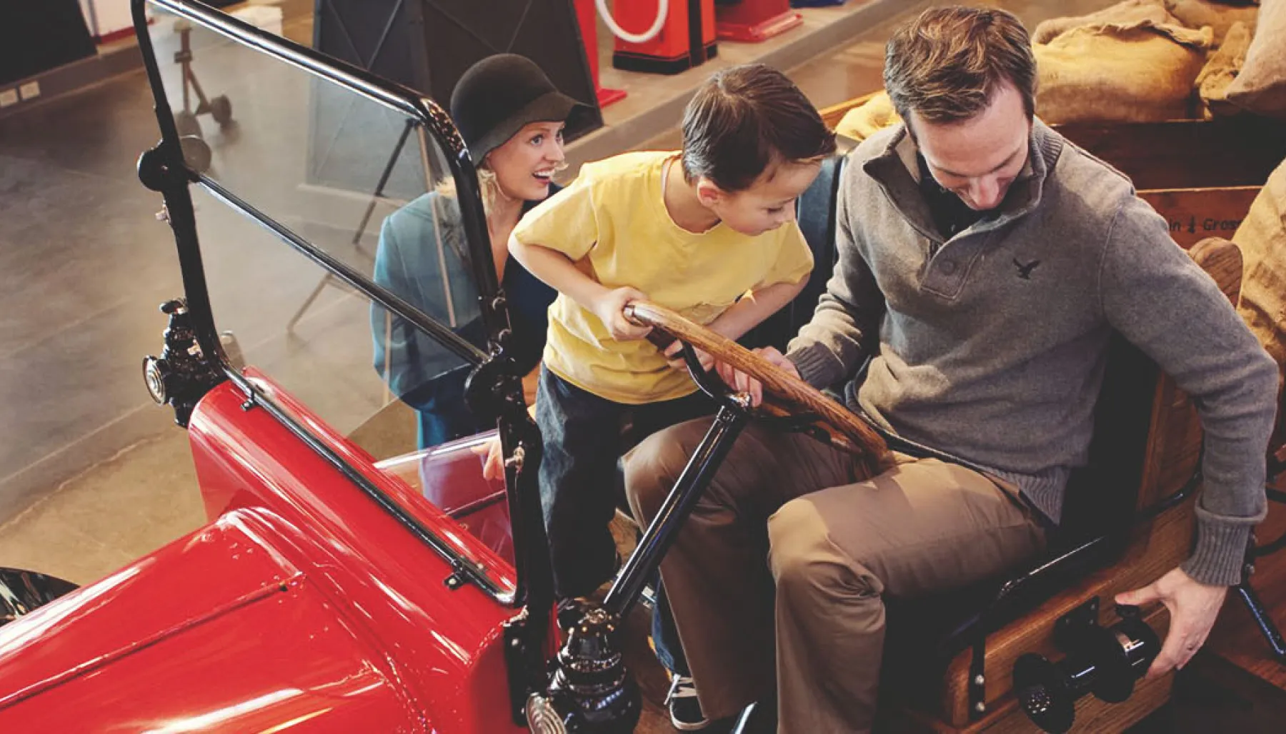 family experiencing a car at the Gasoline Alley Museum Heritage Park