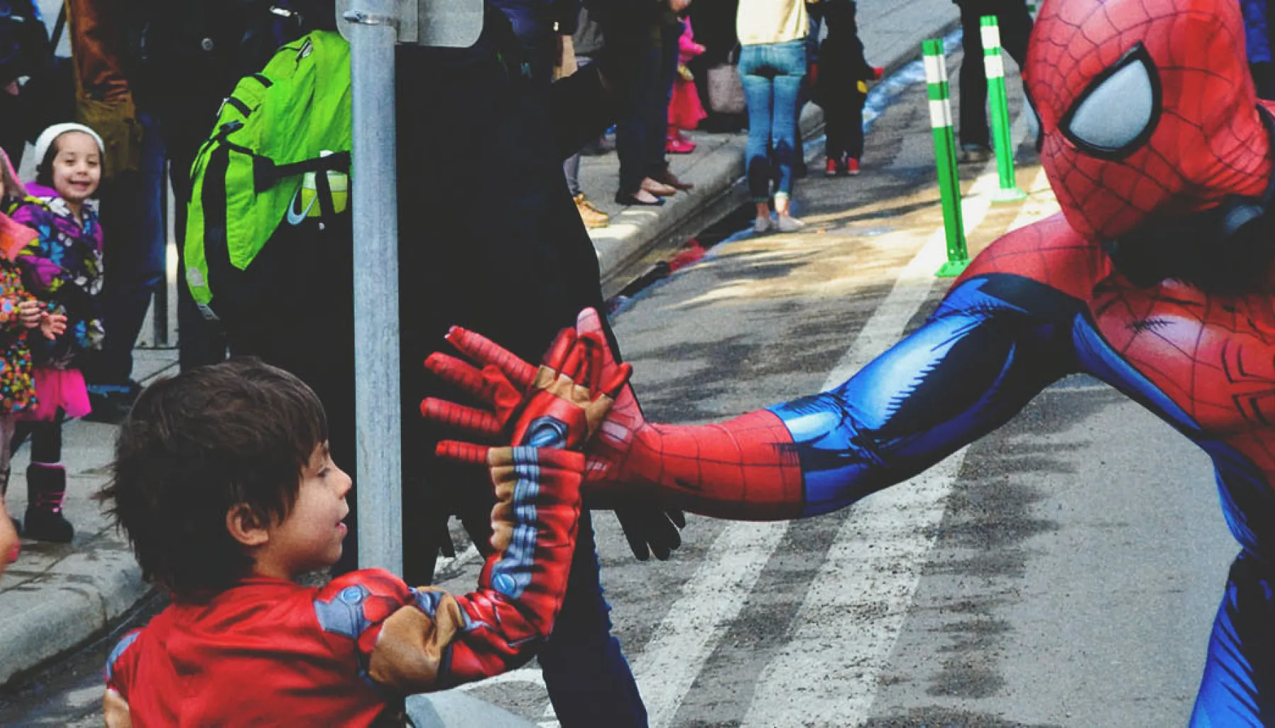 a little boy giving a spiderman a high five at the Calgary expo