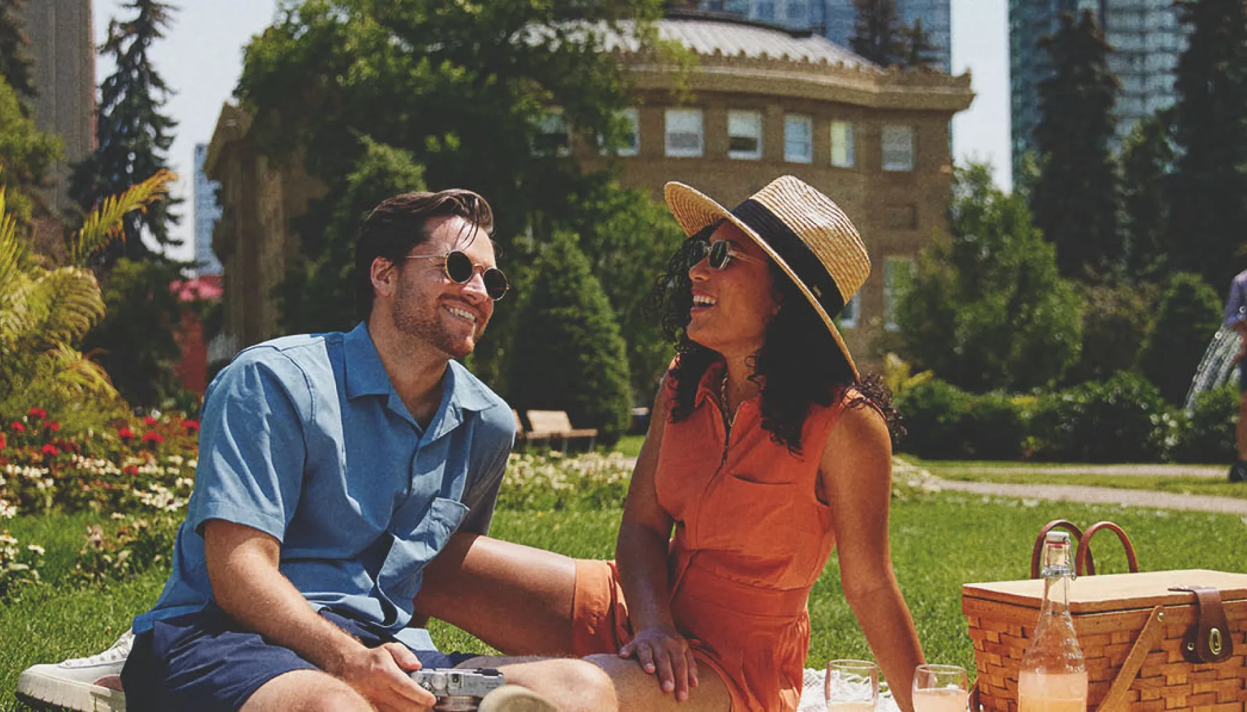 couple laughing and enjoying picnic at Central Memorial Park in Calgary