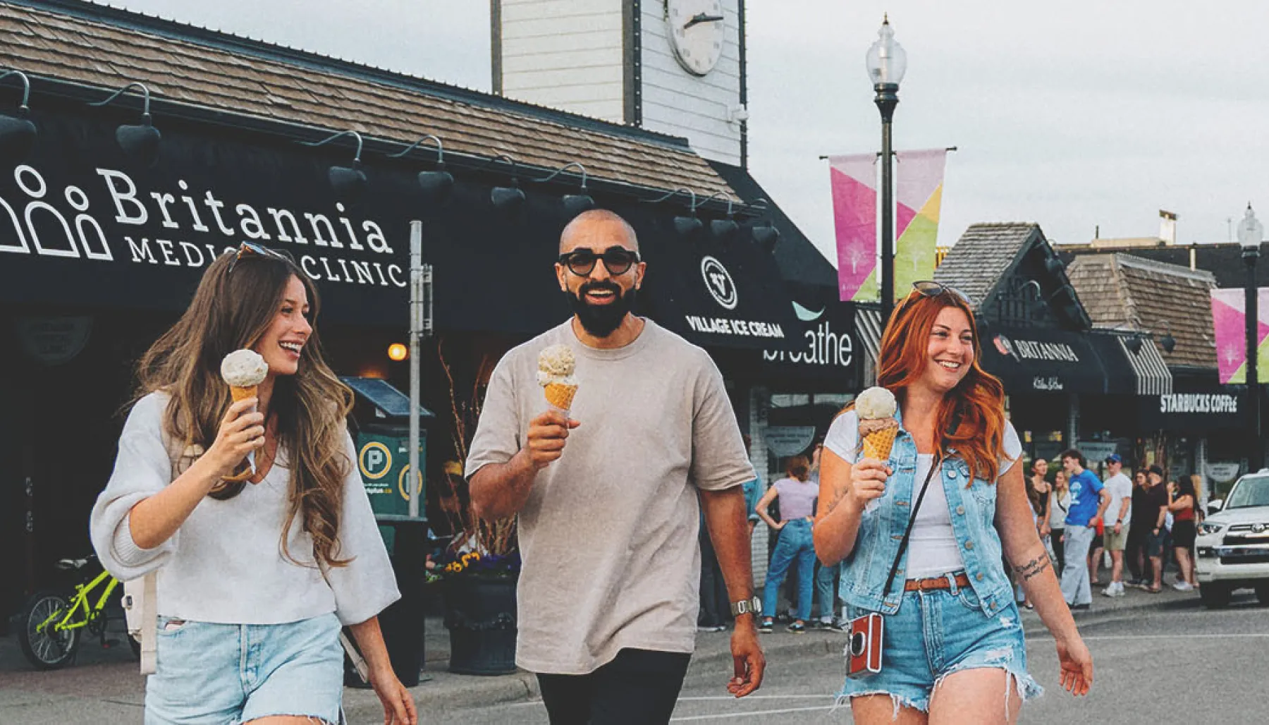 group of friends walking and enjoying ice cream from Village Ice Cream