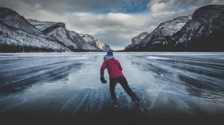 Woman skating on Lake Louise in winter