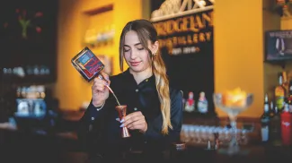 Mixologist pouring alcohol at Bridgeland Distillery