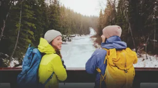 Two ladies hiking through Fish Creek Park during winter