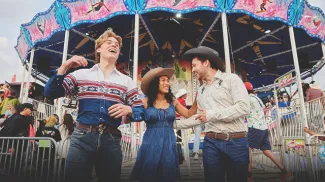 three friends exploring the Calgary Stampede midway