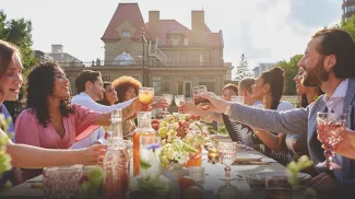 group dining at a long table during a private event held at Lougheed House during spring