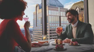 couple dining at Major Tom beside panoramic skyline views