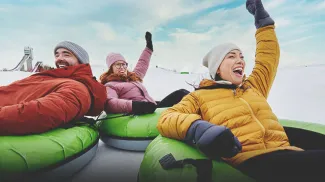 three people are tubing at Winsport Calgary