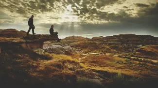 Two travellers overseeing the Badlands by Dinosaur Provincial Park