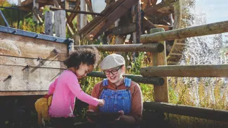 a kid and a lady experiencing gold panning at Heritage Park
