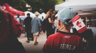 A little boy with a Canadian flag celebrating Canada Day