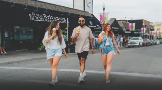 group of friends walking and enjoying ice cream from Village Ice Cream
