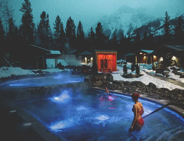 couple relaxing at the Kananaskis Nordic Spa hot pools during winter