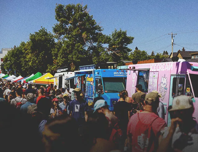 crowds lined up at food trucks during Marda Gras street festival