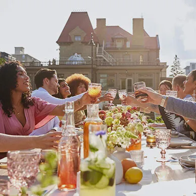 group dining at a long table during a private event held at Lougheed House during spring