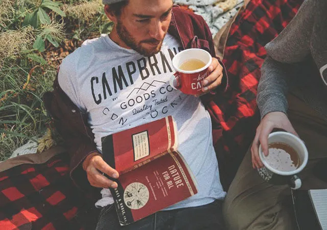 Reading a book in Camp Brand Goods Apparel