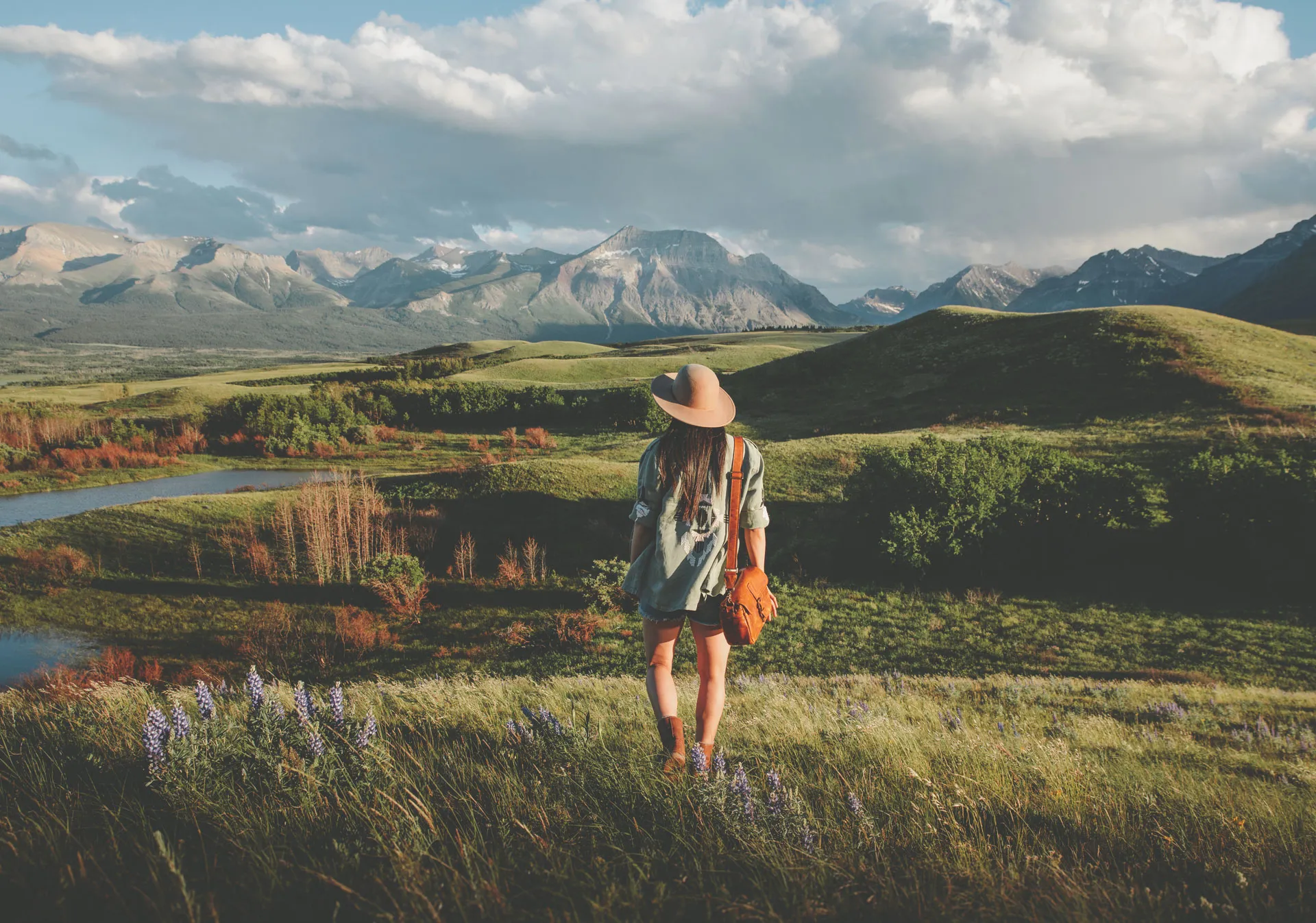 Women walking through a field on a tour of Waterton National Park