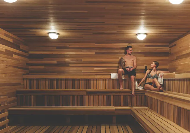 A couple relaxing in the dry sauna at the Kananaskis Nordic Spa (Photo credit: Travel Alberta/Mike Seehagel).