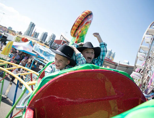 Kid riding a roller coaster at the Calgary Stampede