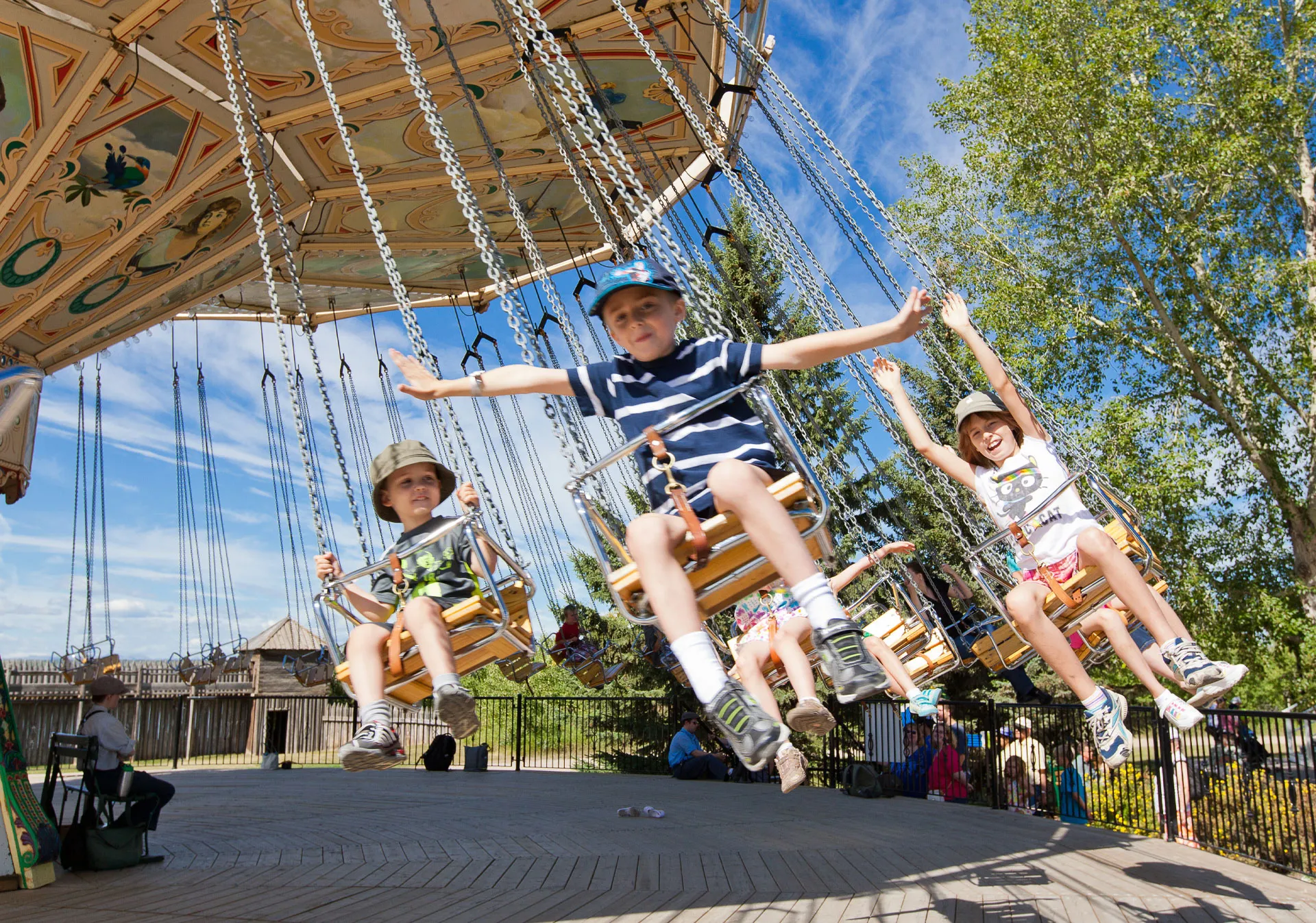 Kids having fun on a ride at Heritage Park Historical Village.