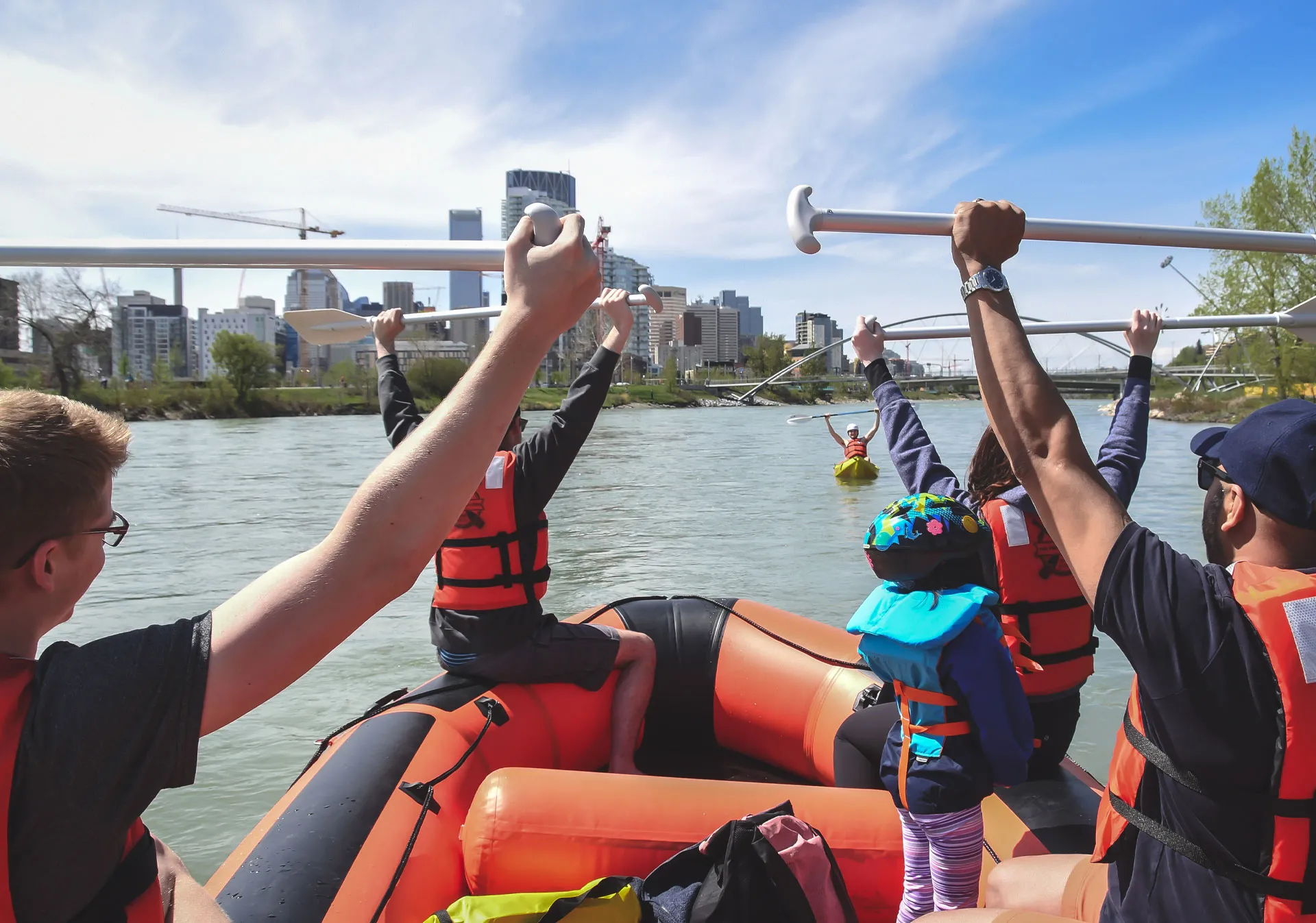 People floating down the Bow River in Calgary with the The Paddle Station.