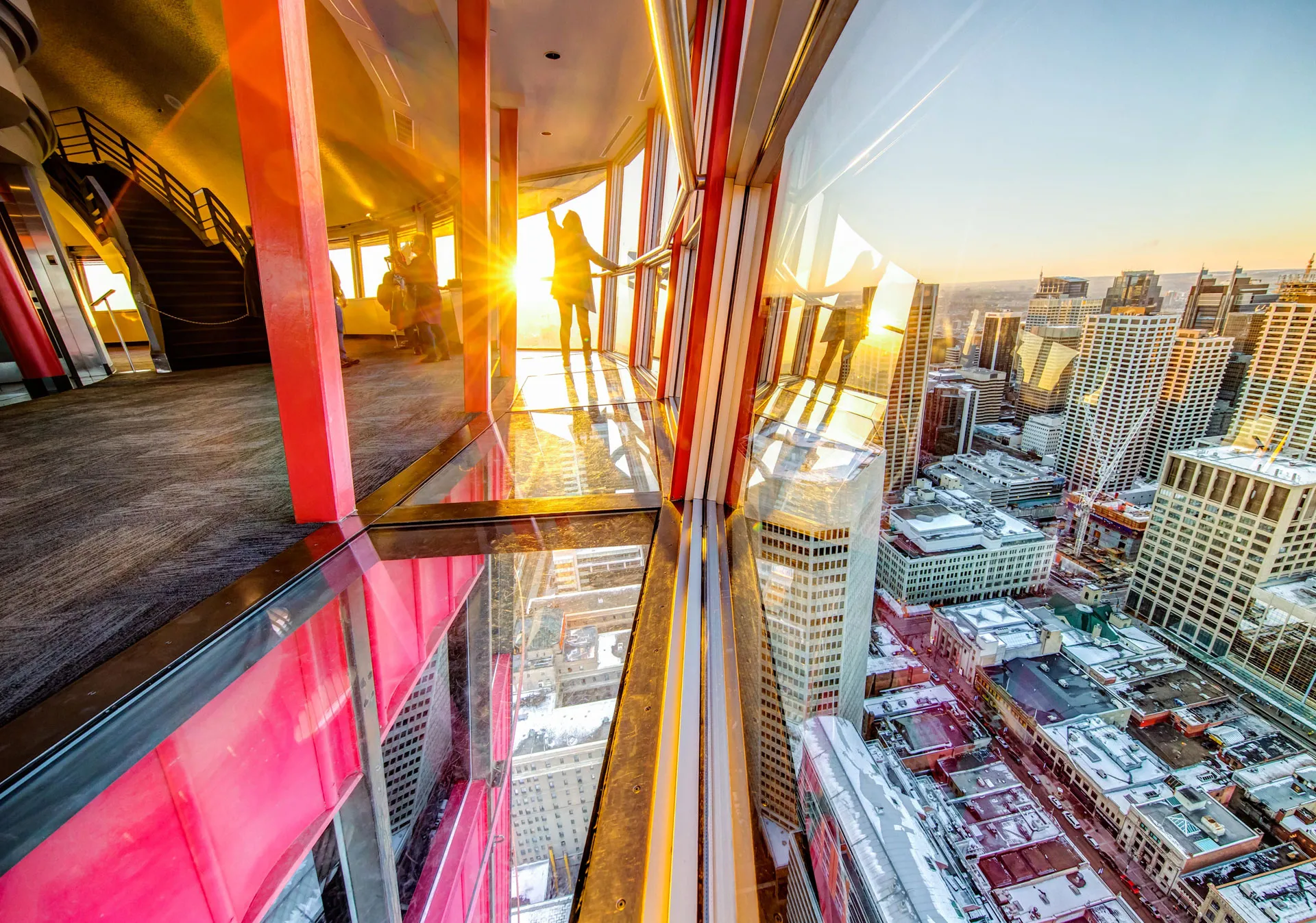 Women looking at the sun setting from the Calgary Tower