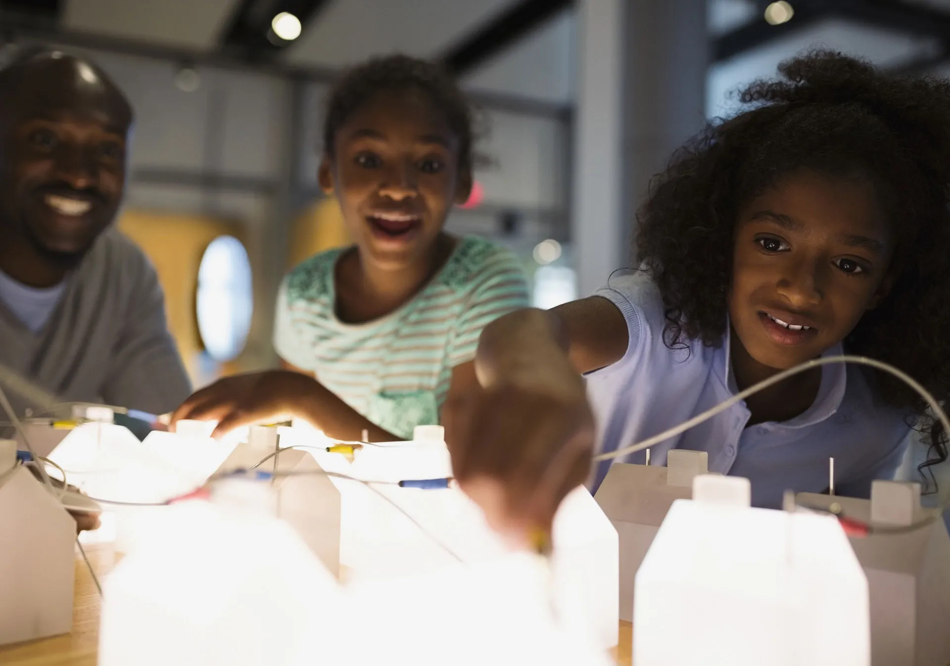 Parent and kids experimenting with science projects at Telus Spark