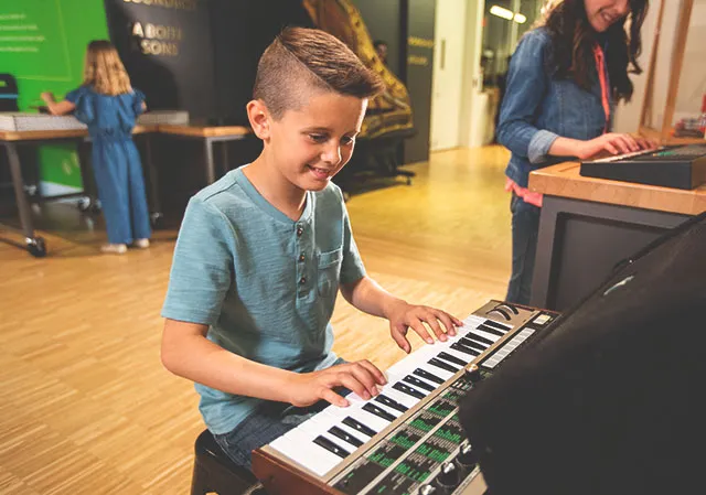 Child interacting with exhibits at Studio Bell