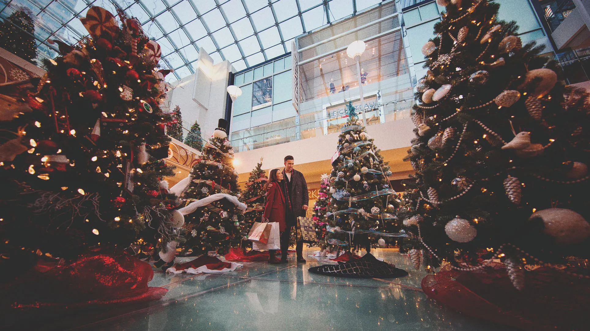 couple admiring a Christmas tree display at a shopping centre in downtown Calgary