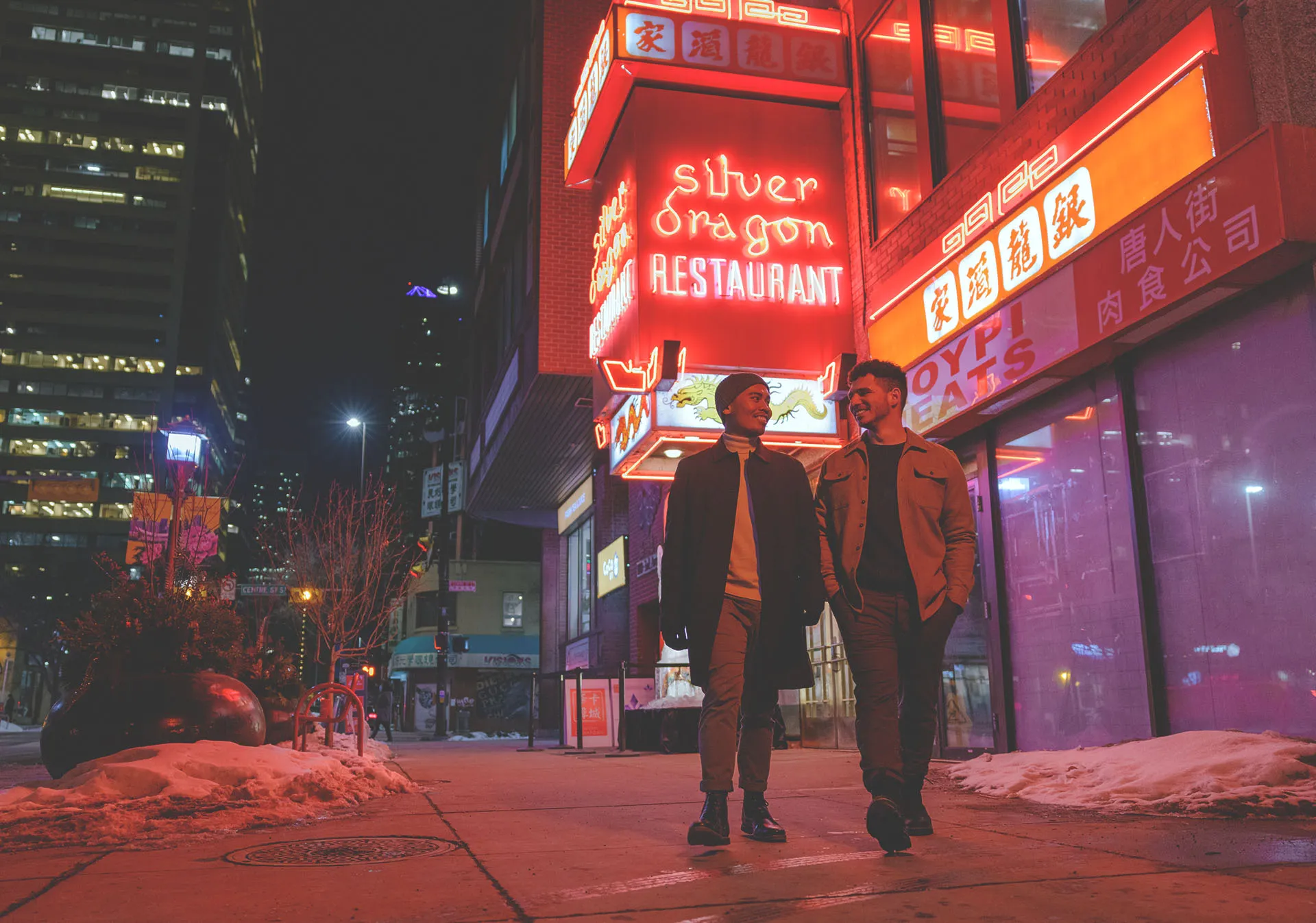 Couple walking past Silver Dragon in Calgary's Chinatown