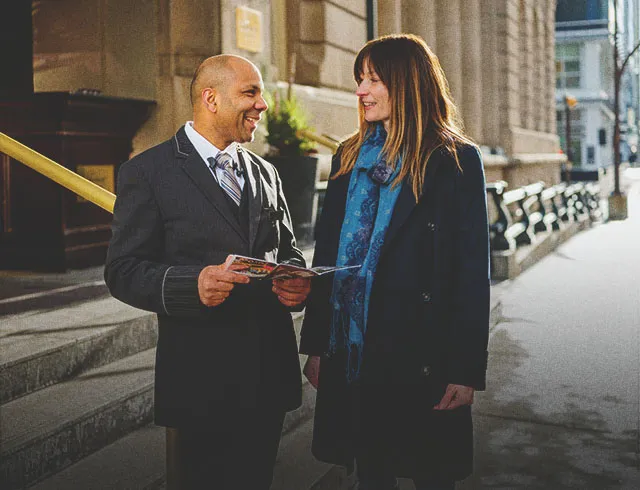 Concierge helping a guest outside the Fairmont Palliser