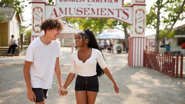 Young couple holding hands and smiling at Heritage Park