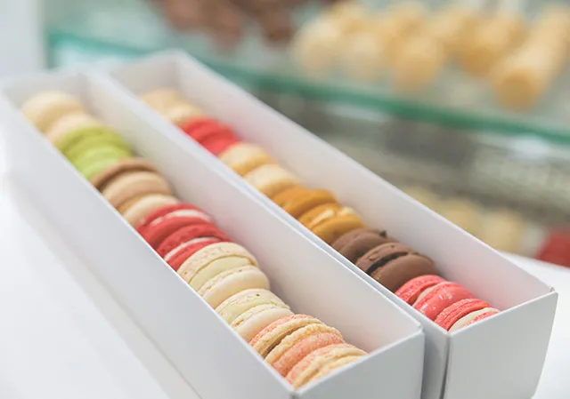 two boxes of colourful macarons from Yann Haute Patisserie